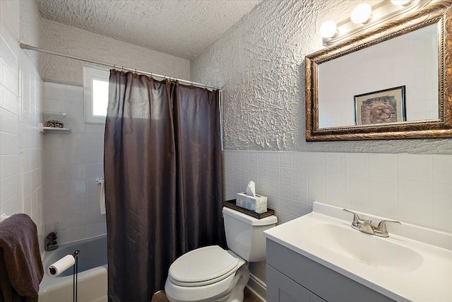 full bathroom with shower / bathtub combination with curtain, tile walls, vanity, a textured ceiling, and toilet