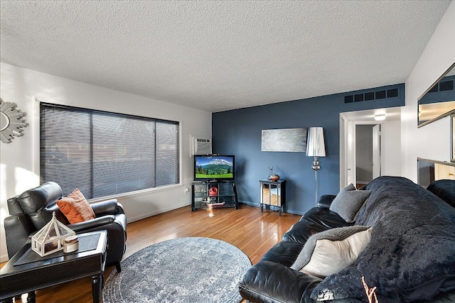 living room with hardwood / wood-style flooring and a textured ceiling