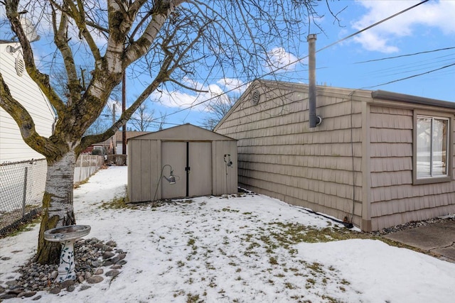 yard layered in snow with a shed