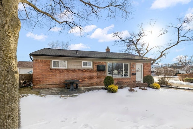 view of snow covered rear of property