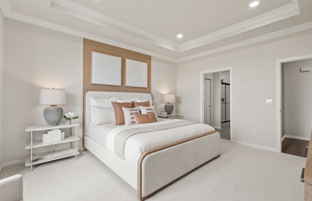 bedroom featuring crown molding, carpet floors, and a raised ceiling