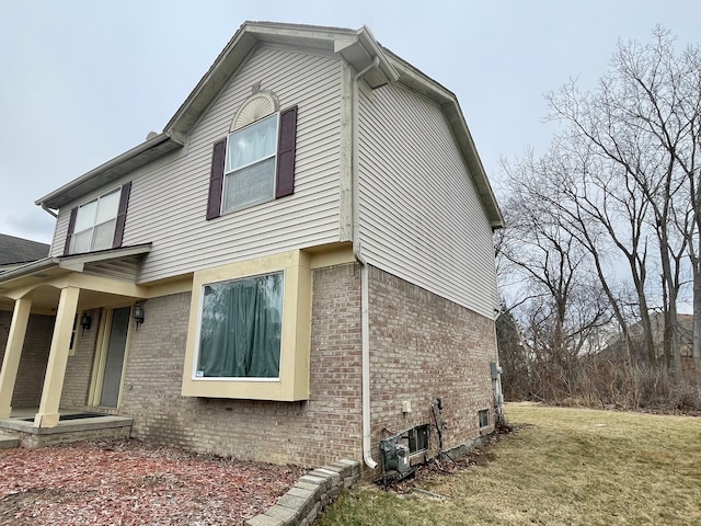 view of side of home with a lawn