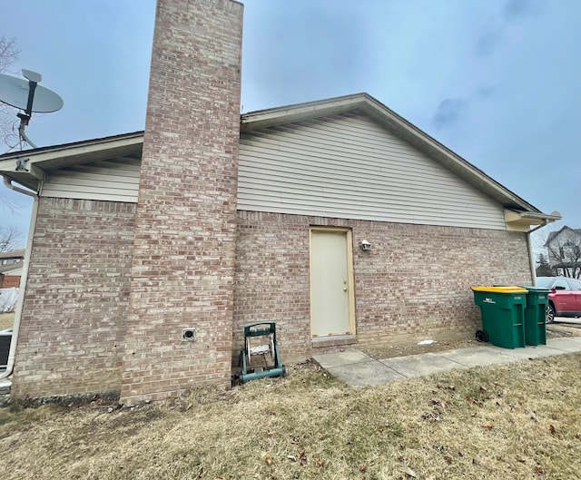 rear view of property featuring a yard