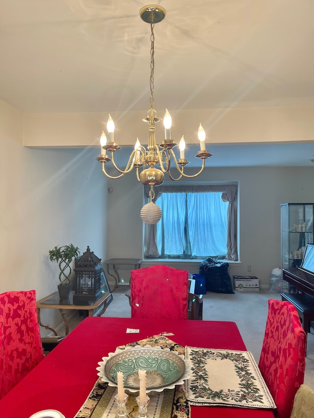 dining room featuring carpet floors and a chandelier