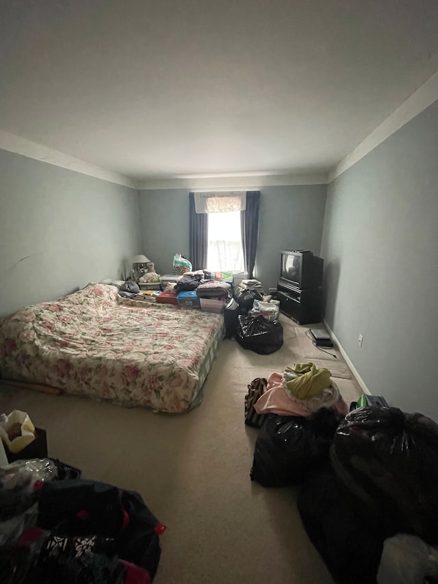 carpeted bedroom with ornamental molding