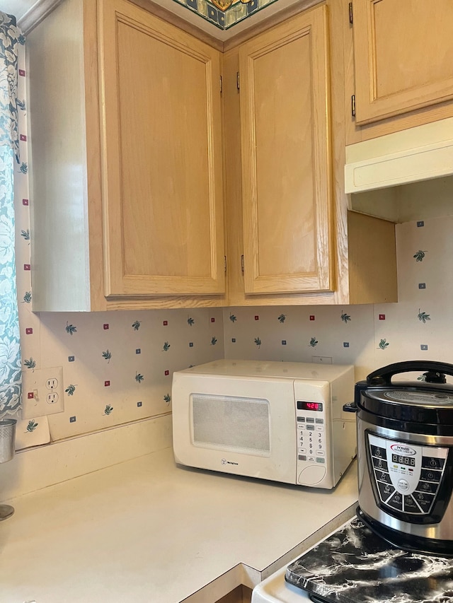 kitchen featuring light brown cabinetry and backsplash