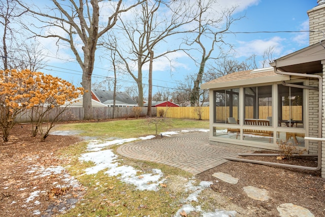 view of yard featuring a patio and a sunroom