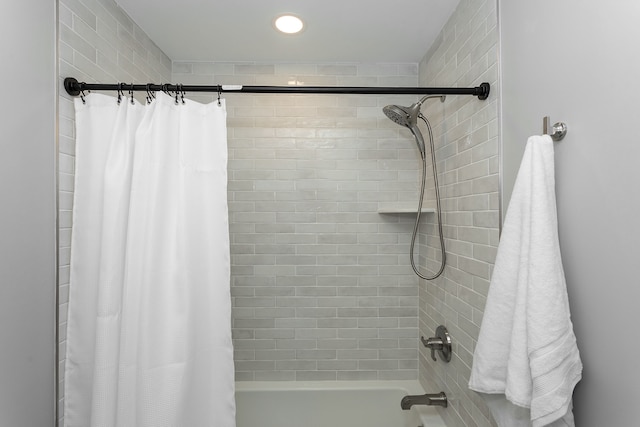 bathroom with shower / bath combo with shower curtain