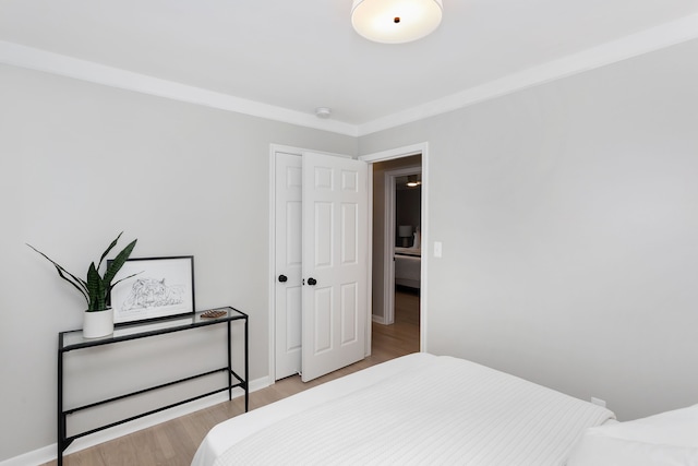 bedroom with a closet and light hardwood / wood-style flooring