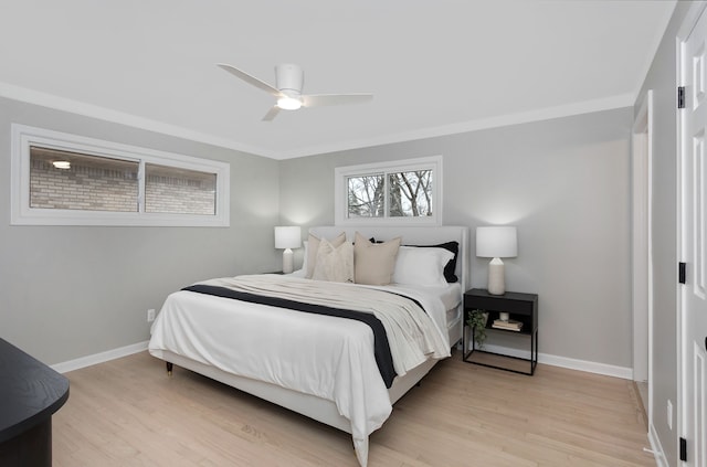 bedroom featuring crown molding, light hardwood / wood-style floors, and ceiling fan