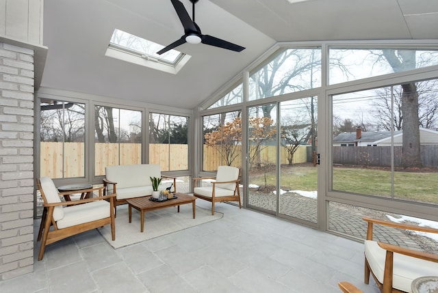 sunroom featuring lofted ceiling with skylight and ceiling fan