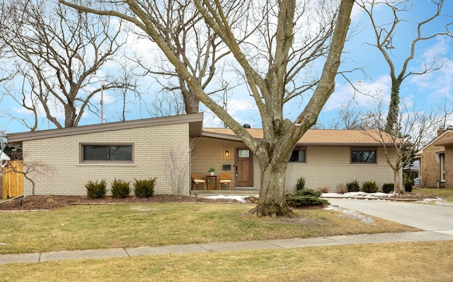 ranch-style home with a front lawn