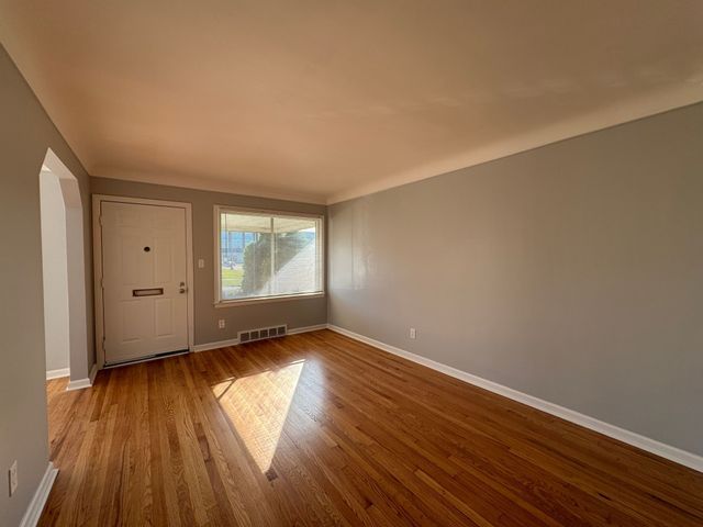 unfurnished room featuring wood-type flooring
