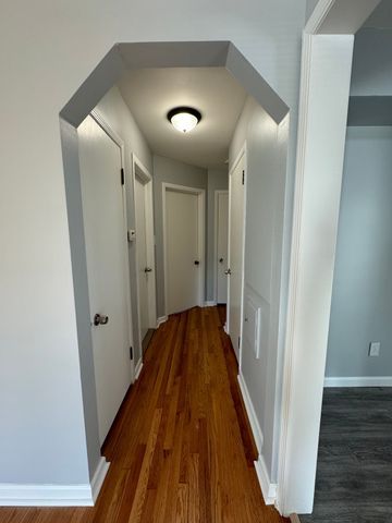 corridor featuring dark hardwood / wood-style flooring