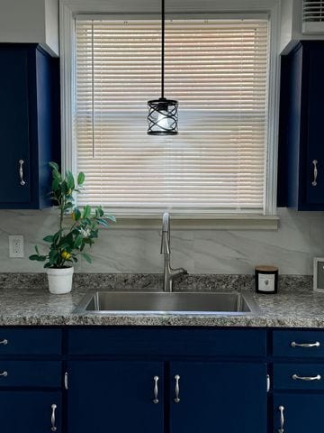 kitchen featuring blue cabinets and sink
