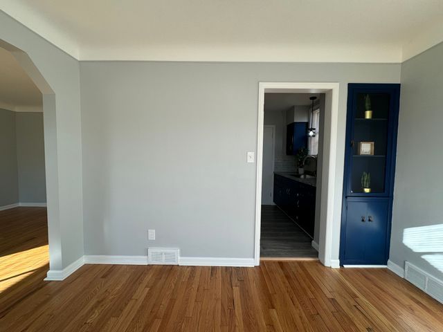 unfurnished room with hardwood / wood-style flooring and built in features