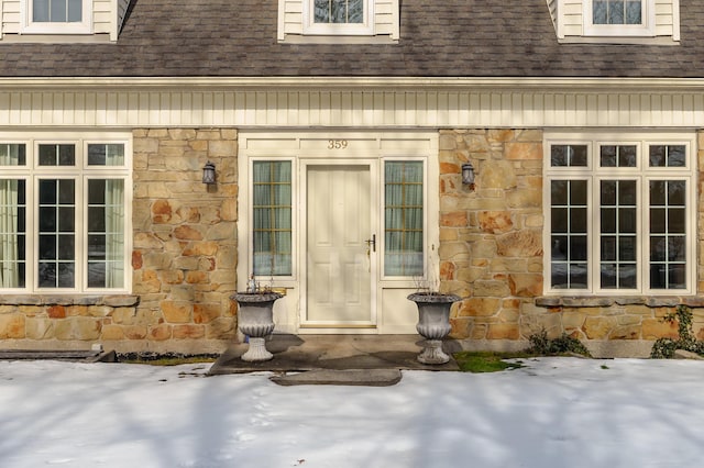 view of snow covered property entrance