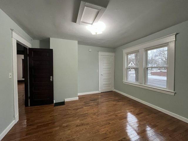 unfurnished bedroom featuring dark wood-type flooring and a closet