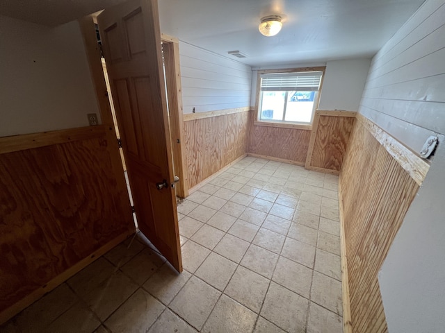 spare room with wooden walls