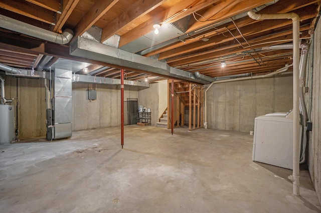 basement with heating unit, washer / dryer, and water heater