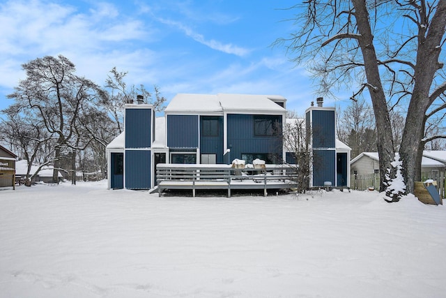 view of snow covered rear of property