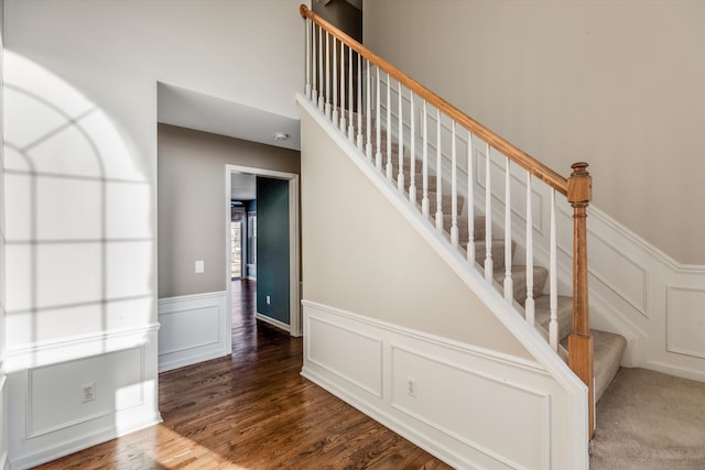 staircase with hardwood / wood-style flooring