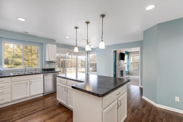 kitchen with pendant lighting, sink, dishwasher, a center island, and white cabinets