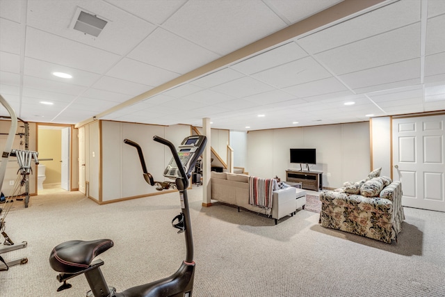 workout room featuring a paneled ceiling and light carpet