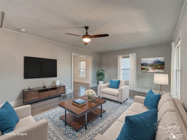 living room featuring ceiling fan, light hardwood / wood-style floors, and a wealth of natural light