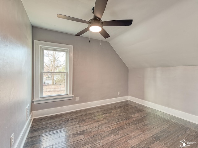 additional living space with ceiling fan, lofted ceiling, and dark hardwood / wood-style flooring