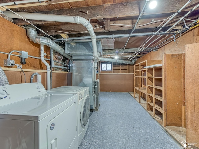 clothes washing area featuring heating unit and washing machine and clothes dryer