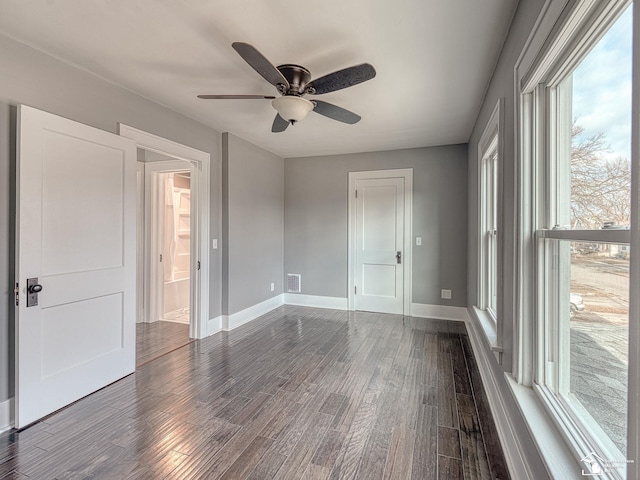 unfurnished bedroom featuring dark hardwood / wood-style floors and ceiling fan