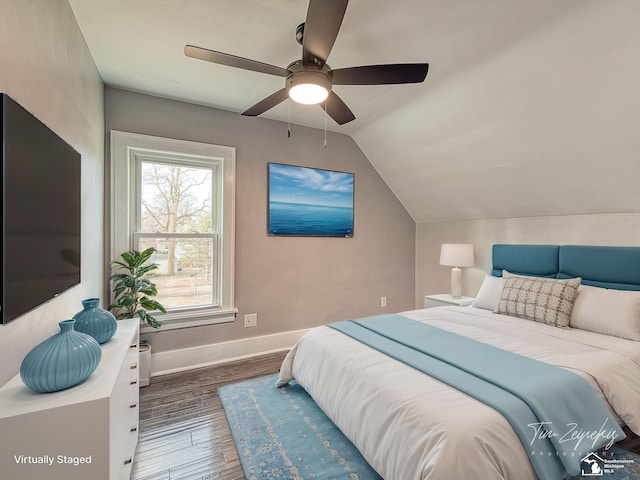 bedroom featuring lofted ceiling, dark hardwood / wood-style floors, and ceiling fan