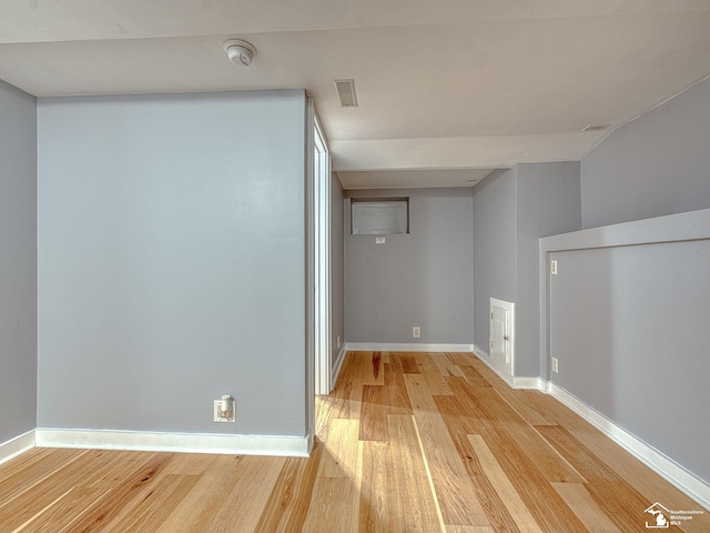 basement with light hardwood / wood-style flooring