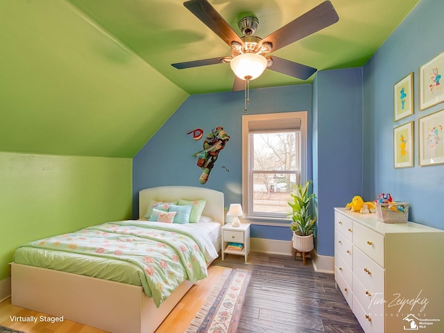 bedroom featuring dark wood-type flooring, ceiling fan, and vaulted ceiling