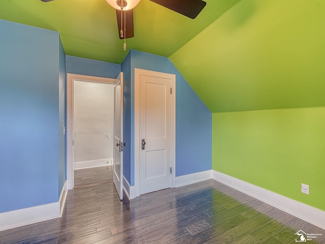 additional living space with ceiling fan, lofted ceiling, and dark hardwood / wood-style flooring