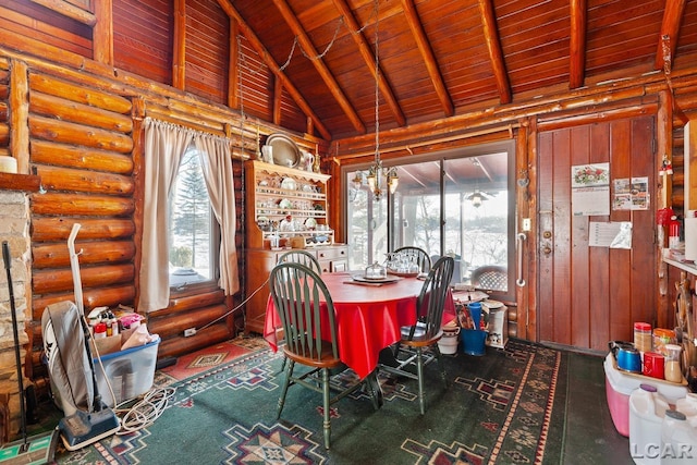 dining space with a notable chandelier, plenty of natural light, wooden ceiling, and high vaulted ceiling