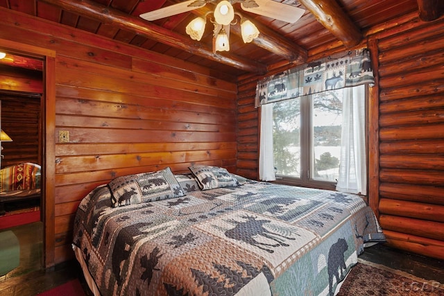 bedroom featuring beam ceiling, log walls, and wooden ceiling