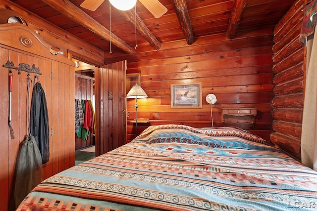 bedroom with beamed ceiling, ceiling fan, and wooden ceiling