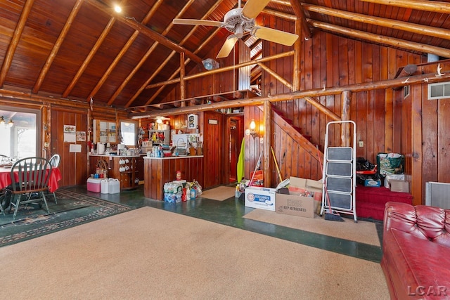 garage with ceiling fan, wood ceiling, and wood walls