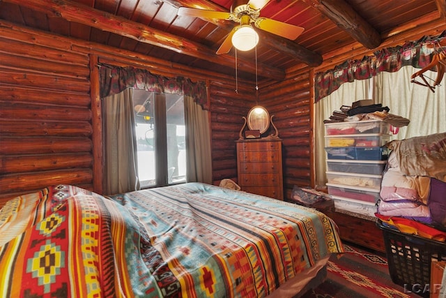 bedroom with beamed ceiling, ceiling fan, and wooden ceiling