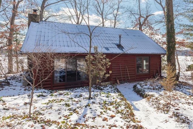 view of snow covered back of property