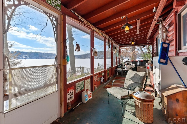 sunroom / solarium with a water view