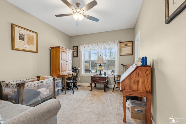 office area featuring light carpet and ceiling fan