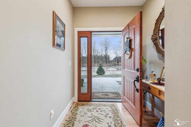 doorway featuring plenty of natural light and light hardwood / wood-style flooring