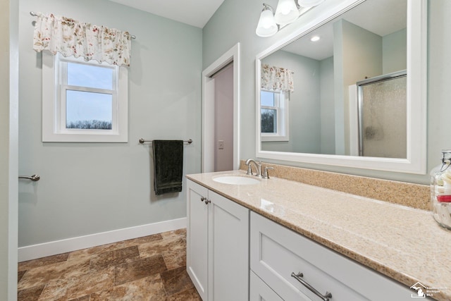 bathroom featuring vanity, a wealth of natural light, and an enclosed shower