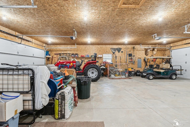 garage featuring a garage door opener and a workshop area