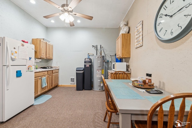 kitchen with light colored carpet, white appliances, ceiling fan, and electric water heater