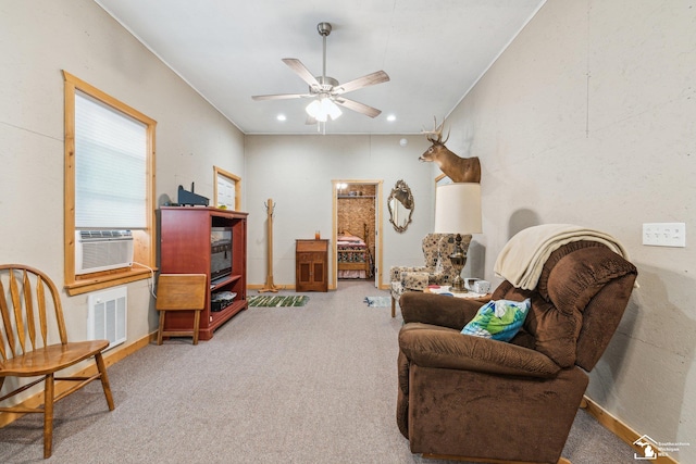 living area with carpet floors, cooling unit, and ceiling fan