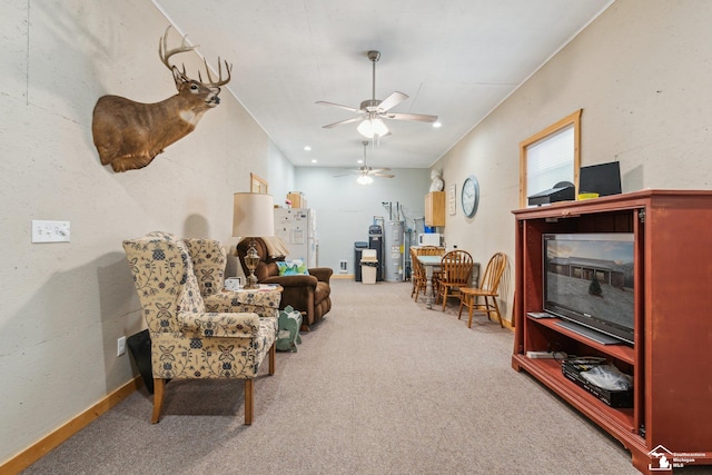 sitting room with ceiling fan and carpet flooring